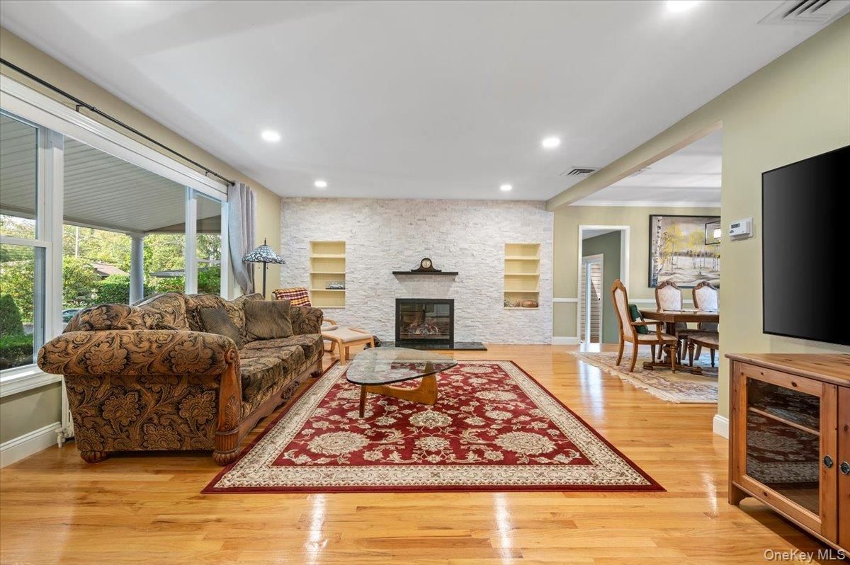 Dining room, Fireplace, Interior, Living room, Recessed Lighting, Stone Walls, Wood Texture Flooring