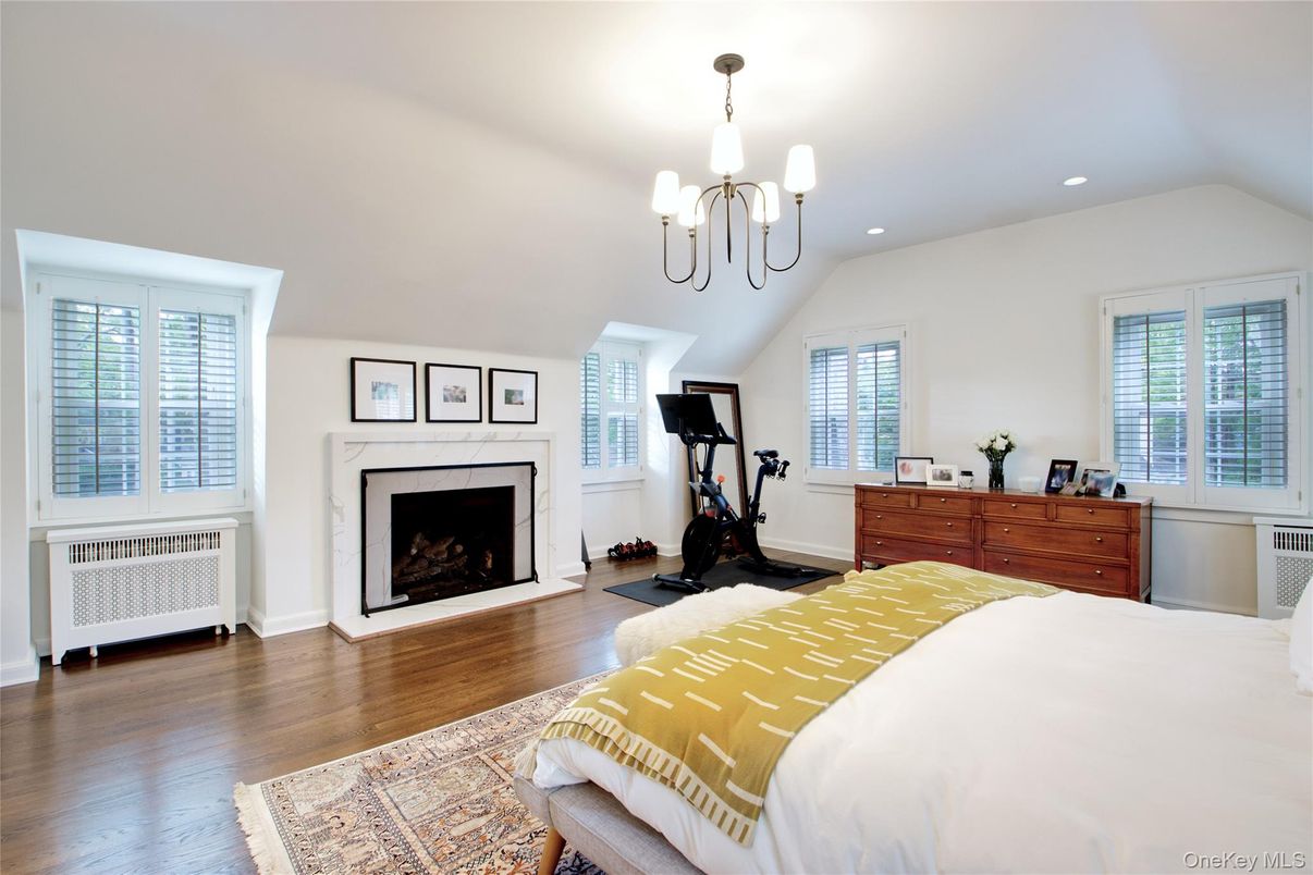 Bedroom, Chandelier, Fireplace, Fitness Equipment, Interior, Recessed Lighting, Wood Texture Flooring