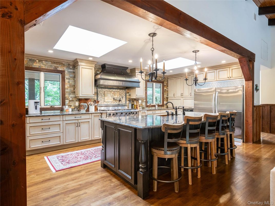 Chandelier, Interior, Kitchen, Pendant Lights, Recessed Lighting, Stainless Steel Appliances, Stone Walls, Wooden Beams, Wood Texture Flooring