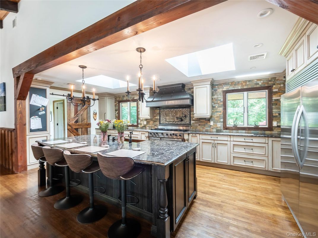 Chandelier, Interior, Kitchen, Pendant Lights, Recessed Lighting, Stainless Steel Appliances, Stone Walls, Wooden Beams, Wood Texture Flooring