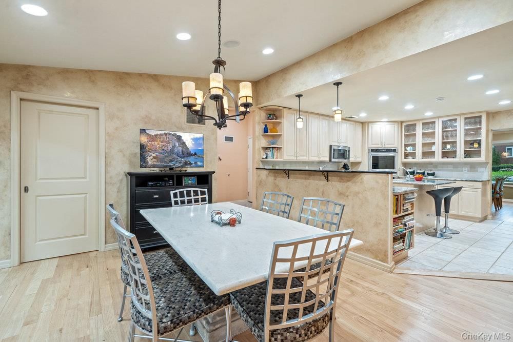 Chandelier, Dining room, Interior, Kitchen, Pendant Lights, Recessed Lighting, Stainless Steel Appliances, Wood Texture Flooring