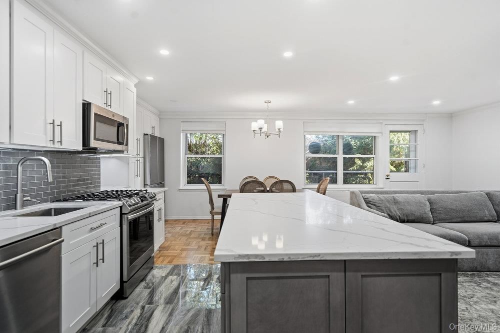 Chandelier, Dining room, Interior, Kitchen, Living room, Pendant Lights, Recessed Lighting, Stainless Steel Appliances, Wood Texture Flooring