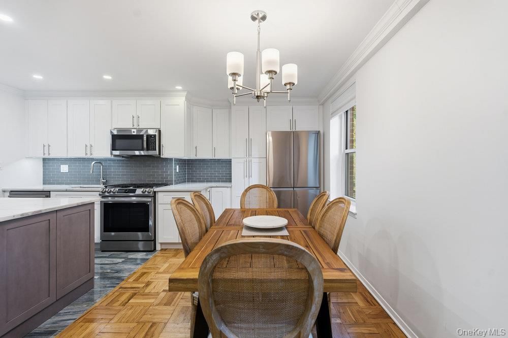Chandelier, Dining room, Interior, Kitchen, Recessed Lighting, Stainless Steel Appliances, Wood Texture Flooring