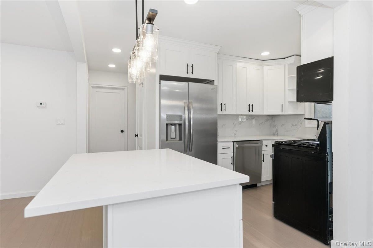 Interior, Kitchen, Marble Walls, Pendant Lights, Recessed Lighting, Stainless Steel Appliances, Wood Texture Flooring