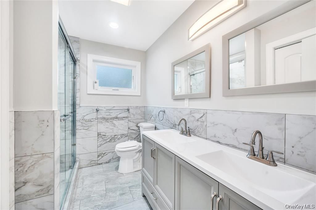 Bathroom, Dual Sink Vanities, Glass Shower, Interior, Marble, Marble Walls, Recessed Lighting