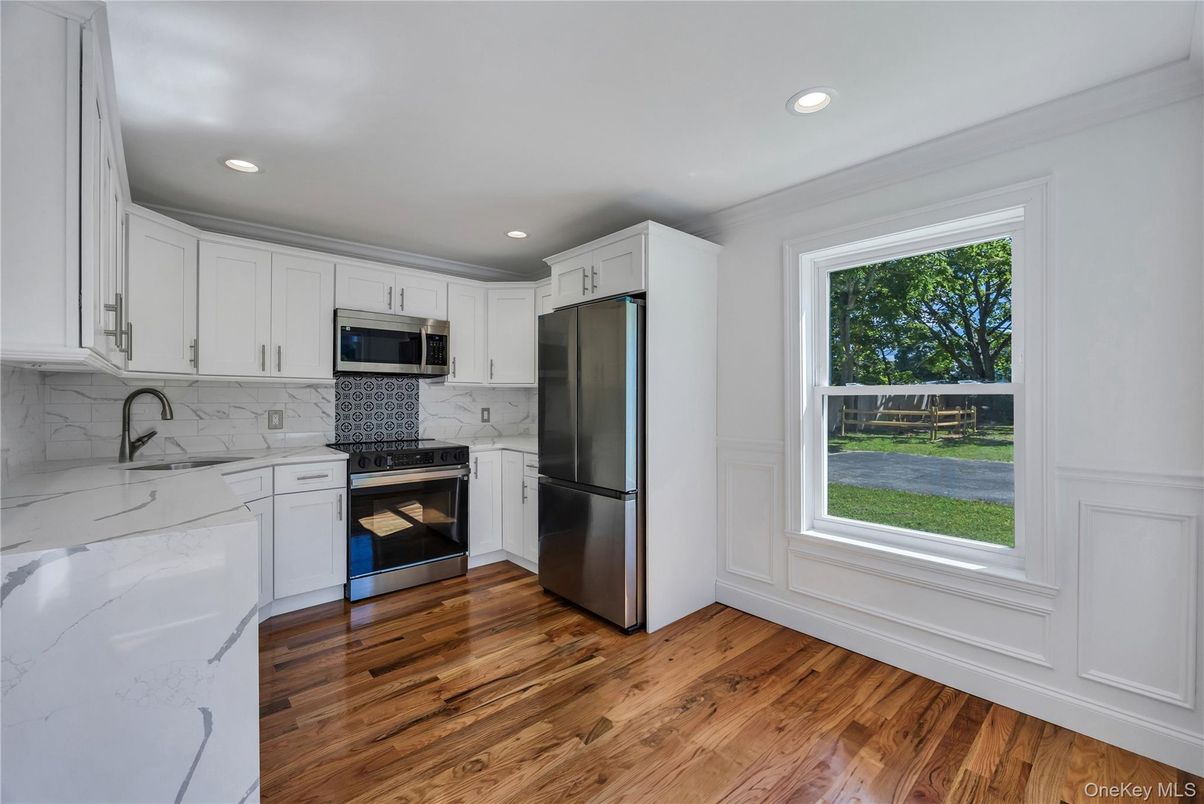 Interior, Kitchen, Marble Walls, Recessed Lighting, Stainless Steel Appliances, Wood Texture Flooring