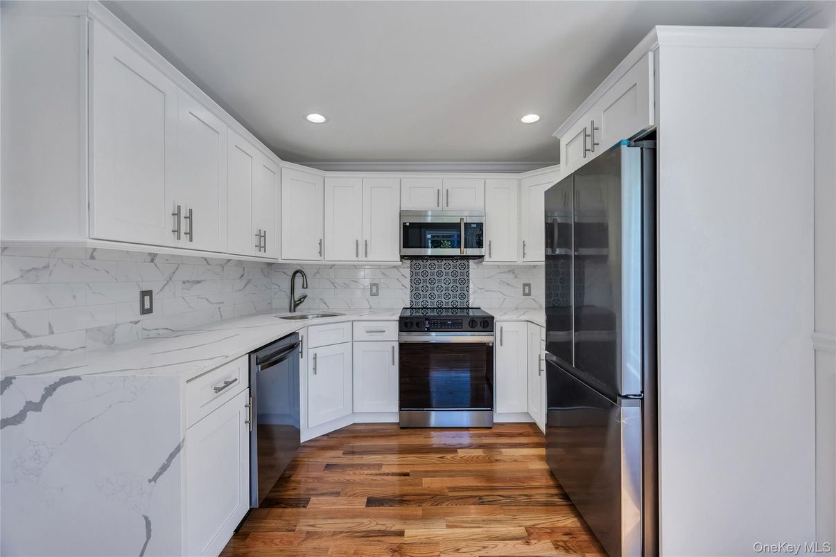 Interior, Kitchen, Marble Walls, Recessed Lighting, Stainless Steel Appliances, Wood Texture Flooring