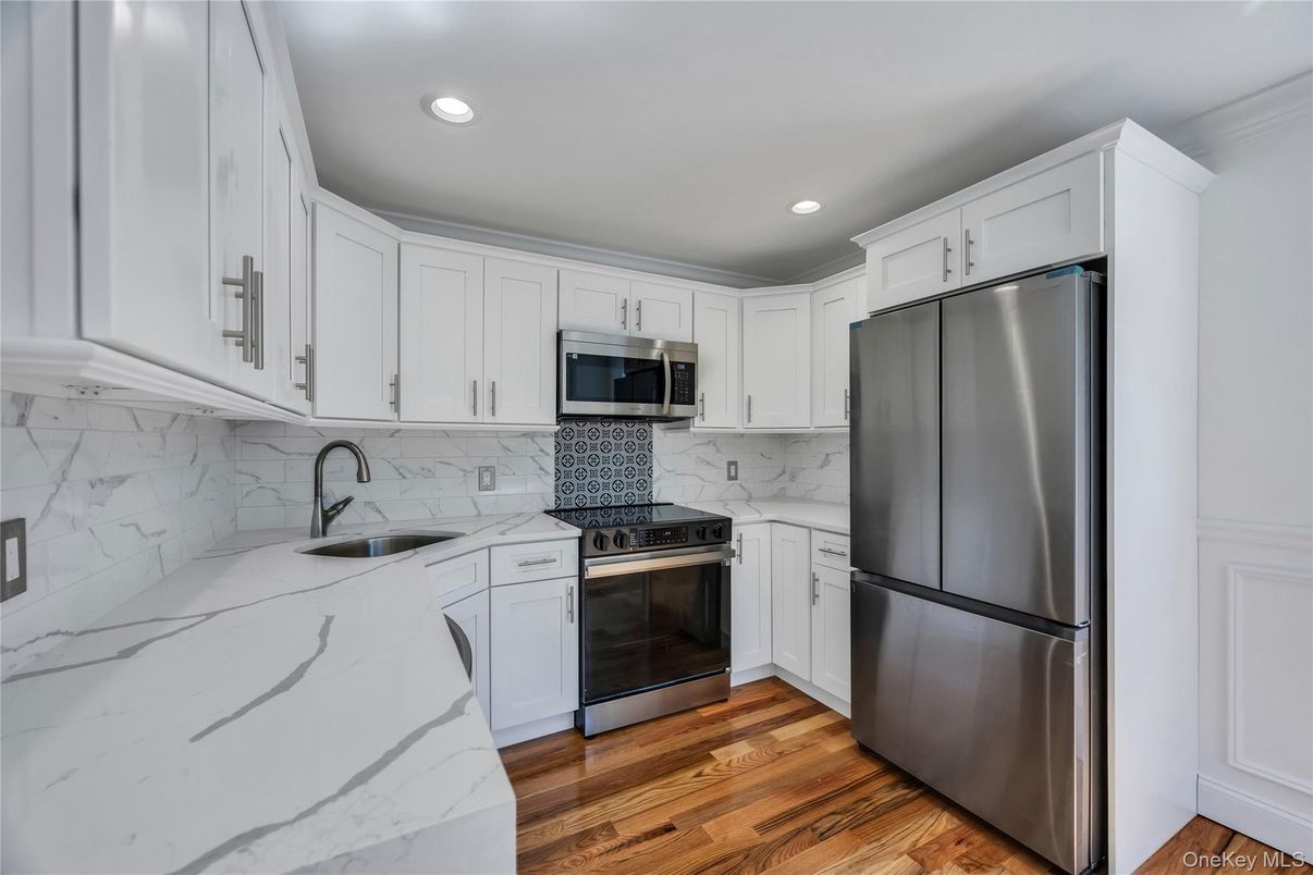 Interior, Kitchen, Marble Walls, Recessed Lighting, Stainless Steel Appliances, Wood Texture Flooring