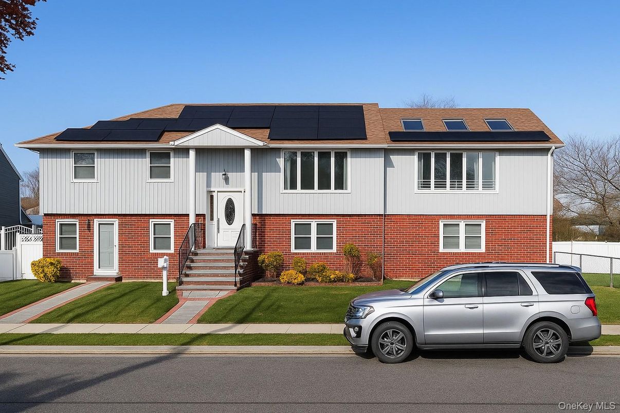 Exterior, Facade, Brick Facade, Solar Panels, Raised Ranch