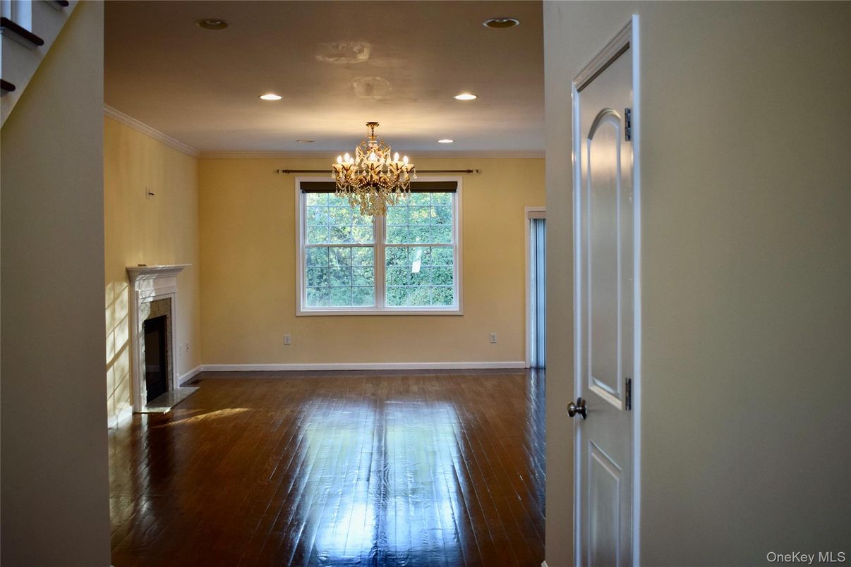 Chandelier, Empty room, Fireplace, Interior, Recessed Lighting, Wood Texture Flooring