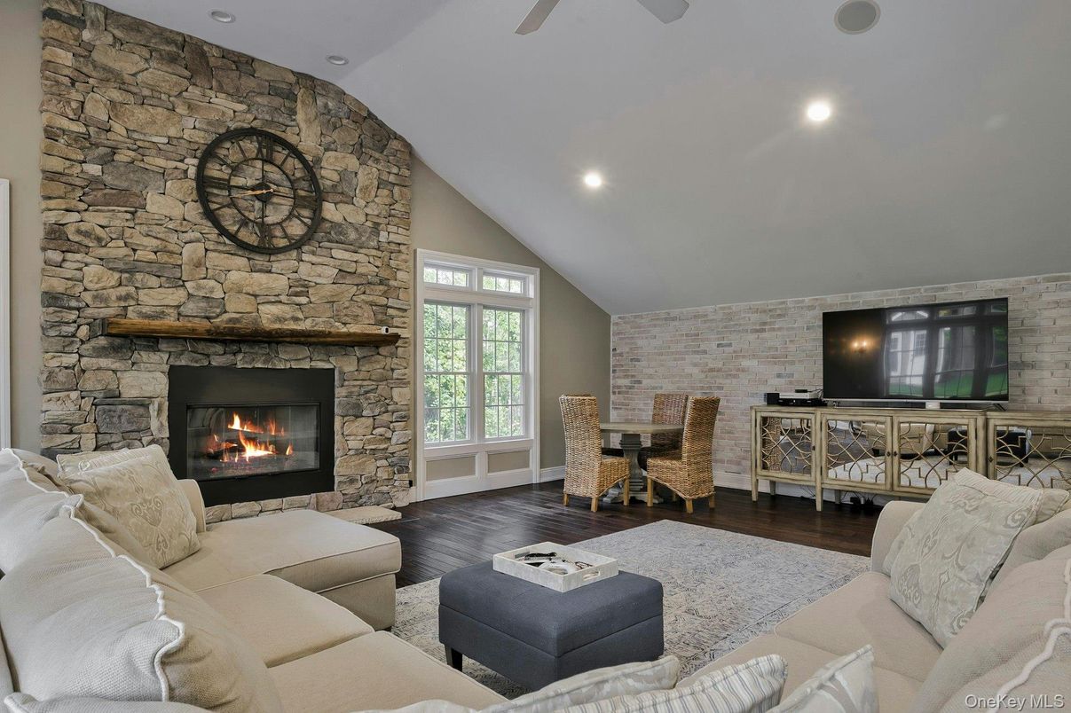 Dining room, Fireplace, Interior, Living room, Recessed Lighting, Stone Walls, Wood Texture Flooring