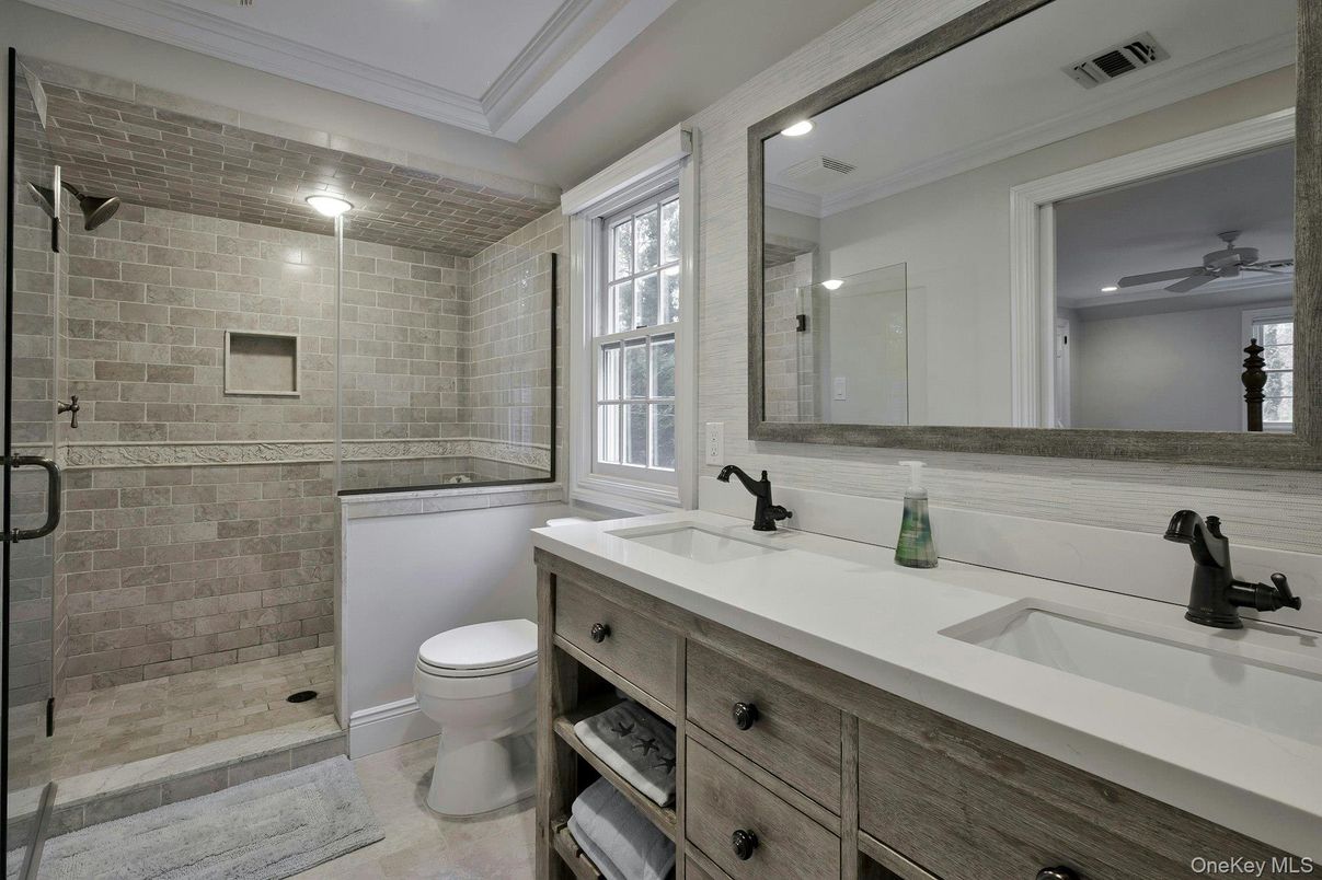Bathroom, Dual Sink Vanities, Glass Shower, Interior, Recessed Lighting, Stone Walls