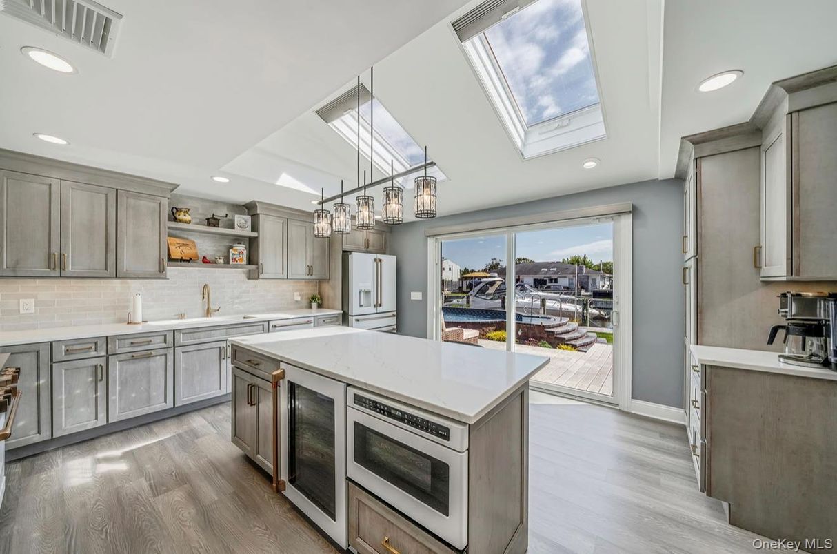 Chandelier, Glass Ceilings, Interior, Kitchen, Recessed Lighting, Stainless Steel Appliances, Wood Texture Flooring