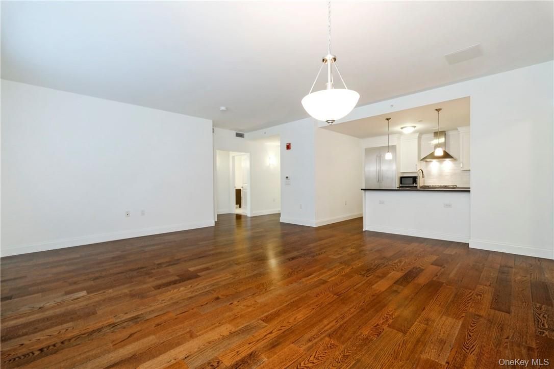 Empty room, Interior, Kitchen, Pendant Lights, Stainless Steel Appliances, Wood Texture Flooring