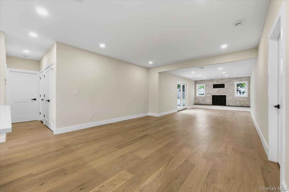 Empty room, Fireplace, Interior, Recessed Lighting, Stone Walls, Wood Texture Flooring