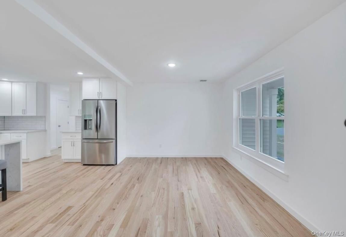 Empty room, Interior, Kitchen, Recessed Lighting, Stainless Steel Appliances, Wood Texture Flooring