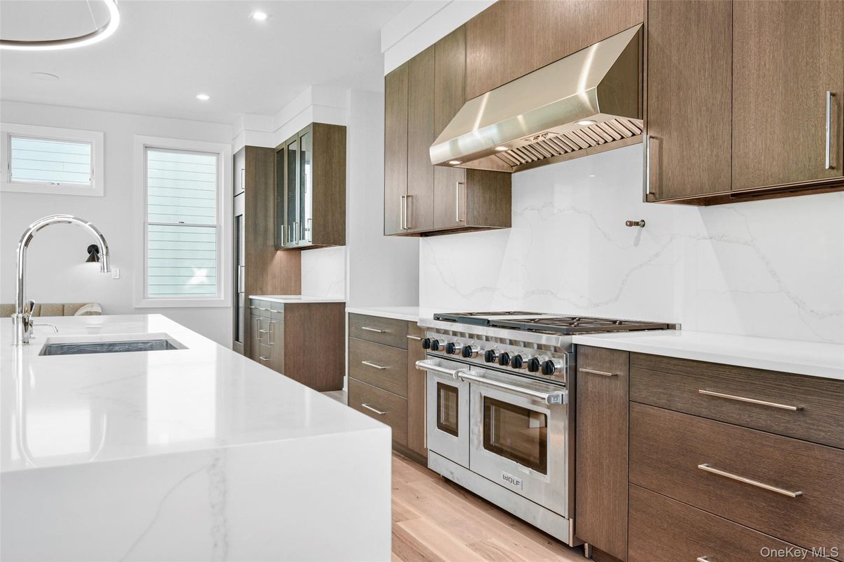 Interior, Kitchen, Marble Walls, Recessed Lighting, Stainless Steel Appliances, Wood Texture Flooring