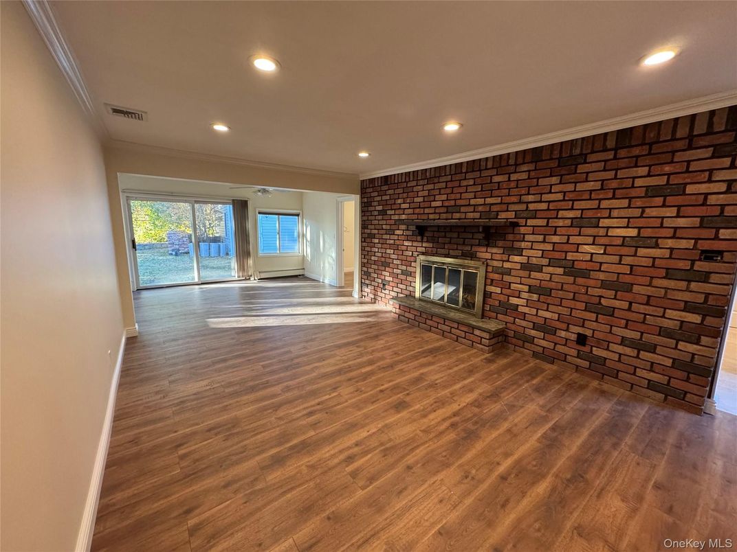 Empty room, Fireplace, Interior, Recessed Lighting, Stone Walls, Wood Texture Flooring