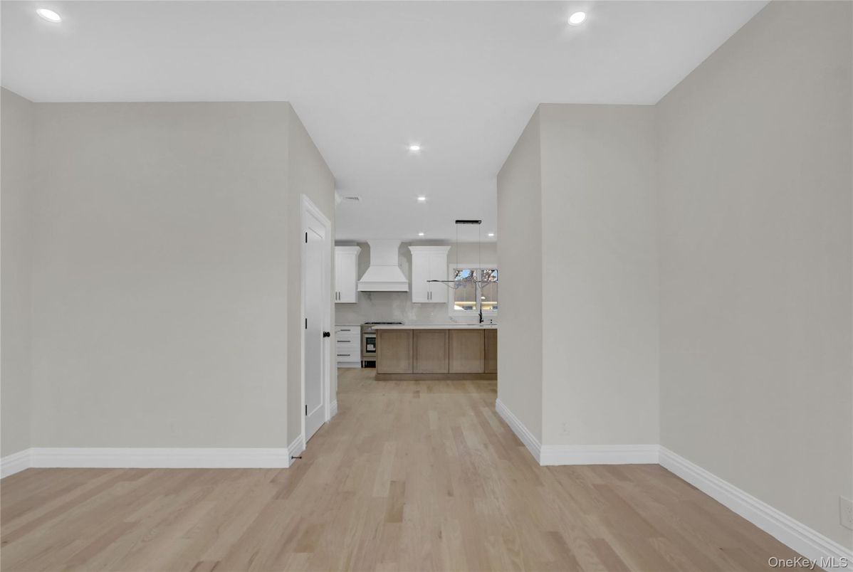 Empty room, Interior, Kitchen, Pendant Lights, Recessed Lighting, Stainless Steel Appliances, Wood Texture Flooring