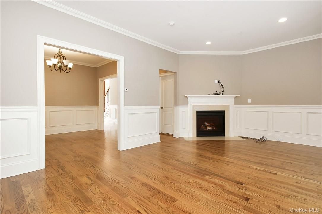 Chandelier, Empty room, Fireplace, Interior, Recessed Lighting, Wood Texture Flooring