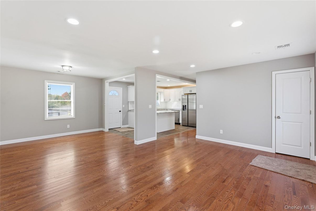 Empty room, Interior, Kitchen, Recessed Lighting, Stainless Steel Appliances, Wood Texture Flooring