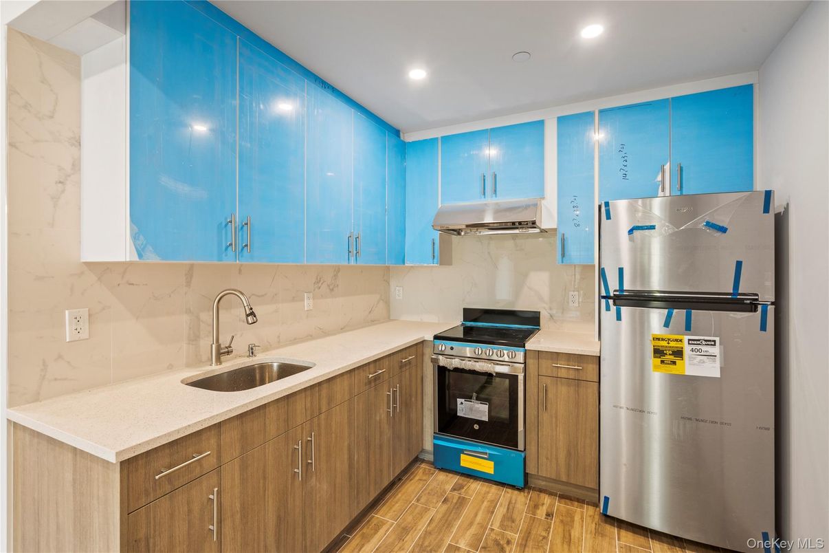 Interior, Kitchen, Marble Walls, Recessed Lighting, Stainless Steel Appliances, Wood Texture Flooring