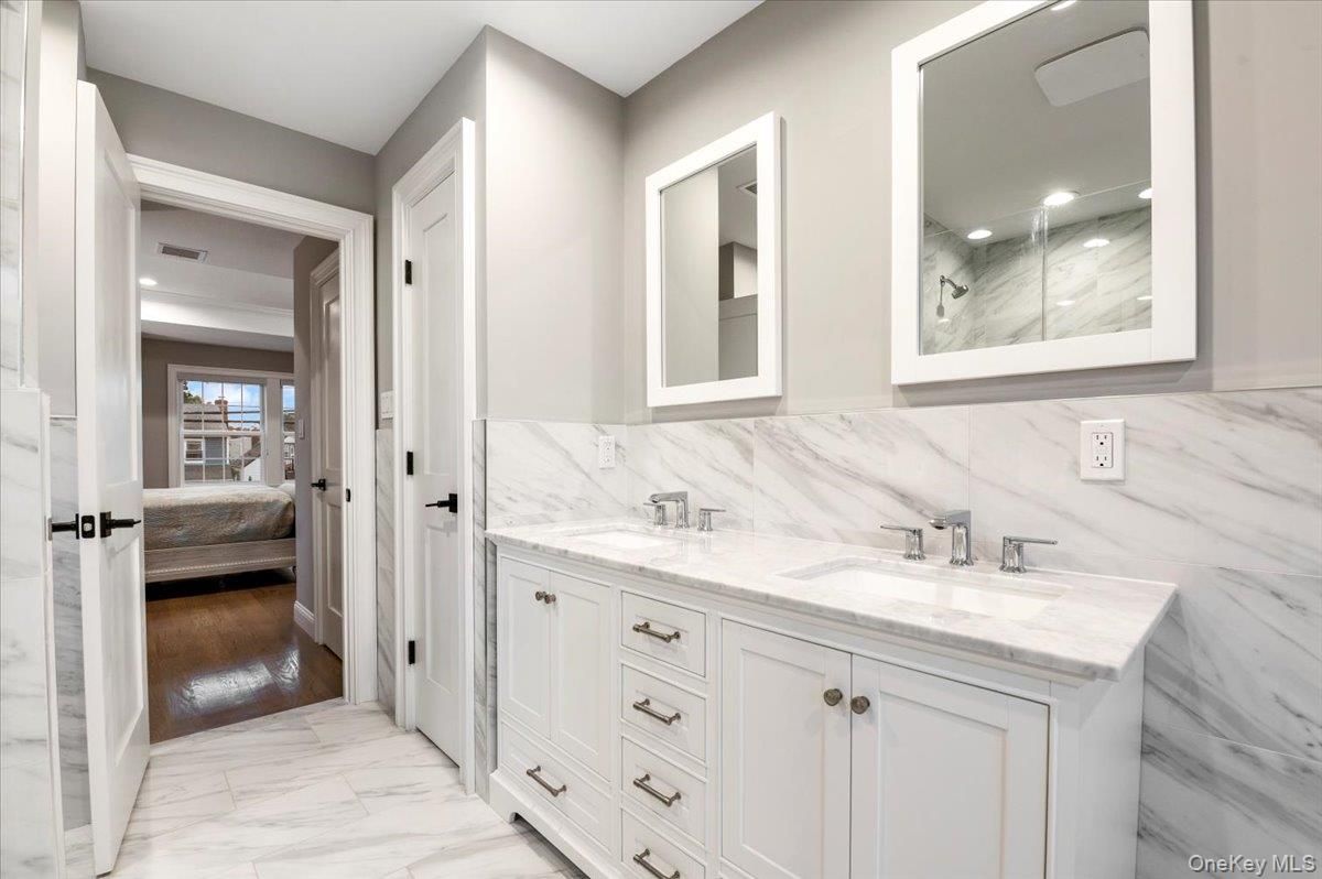 Bathroom, Bedroom, Dual Sink Vanities, Interior, Marble, Marble Walls, Recessed Lighting, Wood Texture Flooring