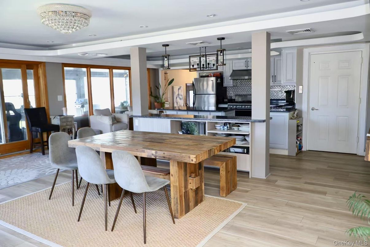 Chandelier, Dining room, Interior, Kitchen, Pendant Lights, Recessed Lighting, Stainless Steel Appliances, Wood Texture Flooring