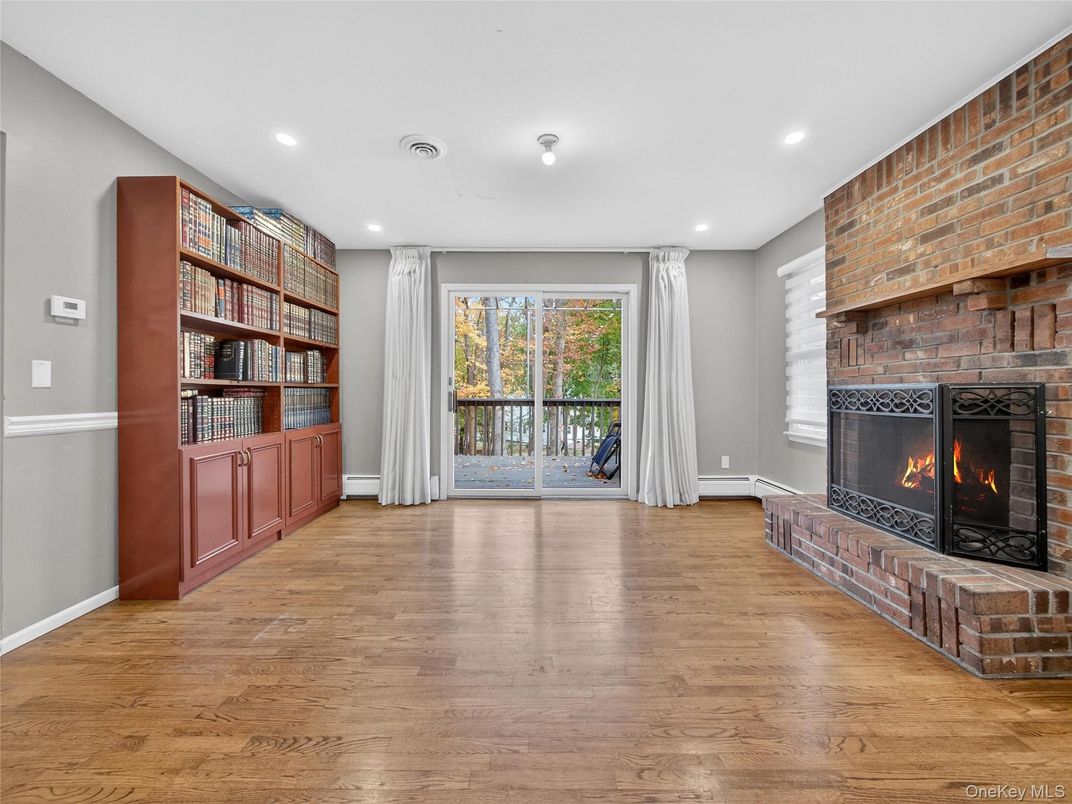 Empty room, Fireplace, Interior, Recessed Lighting, Stone Walls, Wood Texture Flooring