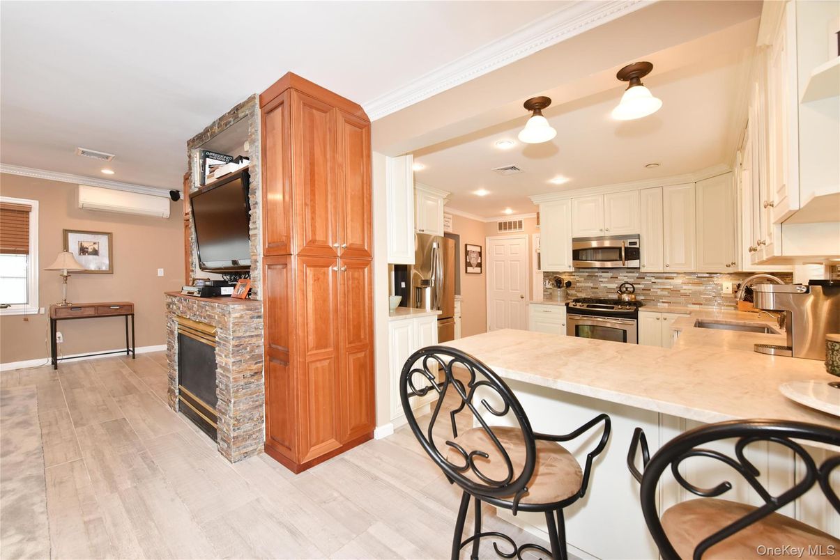 Fireplace, Interior, Kitchen, Pendant Lights, Recessed Lighting, Stainless Steel Appliances, Wood Texture Flooring