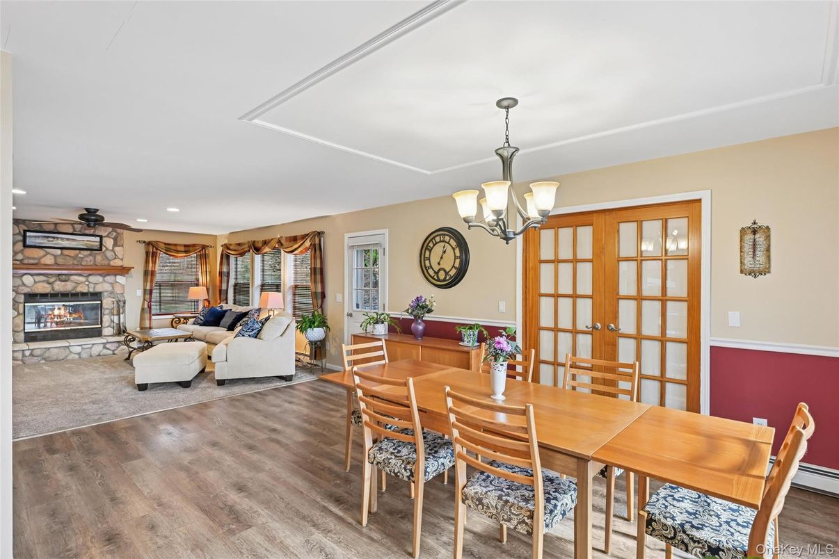 Chandelier, Dining room, Fireplace, Interior, Living room, Recessed Lighting, Stone Walls, Wood Texture Flooring