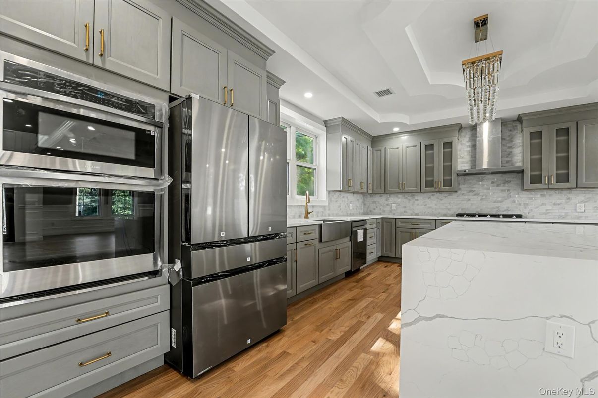 Interior, Kitchen, Marble Walls, Recessed Lighting, Stainless Steel Appliances, Wood Texture Flooring