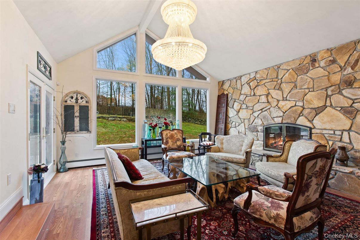 Chandelier, Fireplace, Interior, Living room, Stone Walls, Wood Texture Flooring