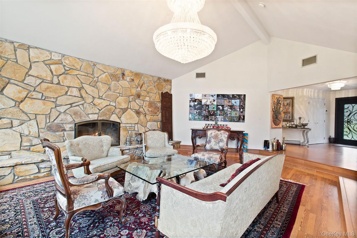 Chandelier, Dining room, Fireplace, Interior, Living room, Stone Walls, Wood Texture Flooring
