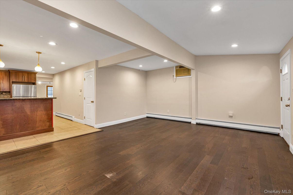 Empty room, Interior, Kitchen, Pendant Lights, Recessed Lighting, Stainless Steel Appliances, Wood Texture Flooring