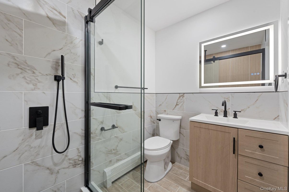 Bathroom, Glass Shower, Interior, Marble Walls, Recessed Lighting, Wood Texture Flooring