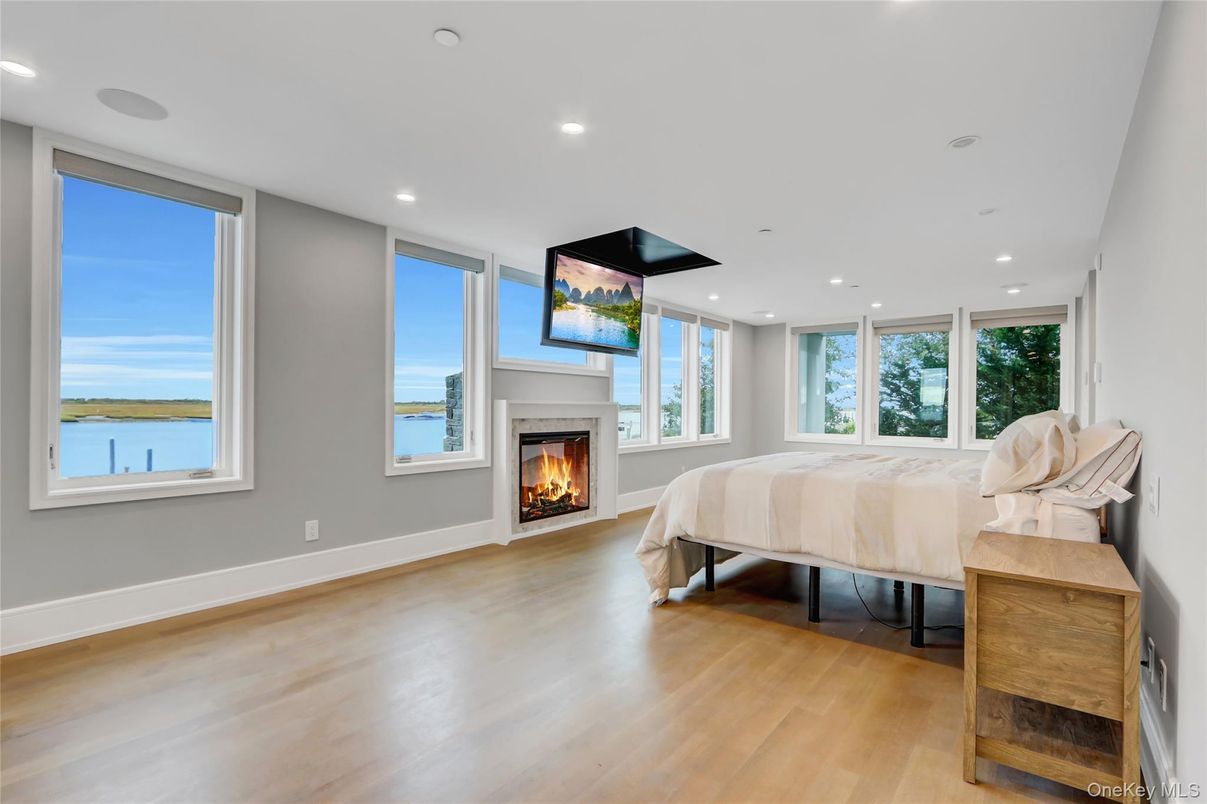 Bedroom, Fireplace, Interior, Recessed Lighting, Water, Wood Texture Flooring