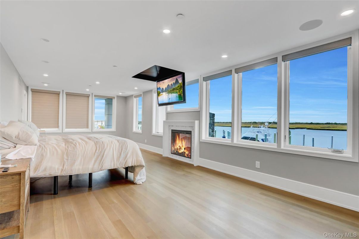 Bedroom, Fireplace, Interior, Recessed Lighting, Water, Wood Texture Flooring