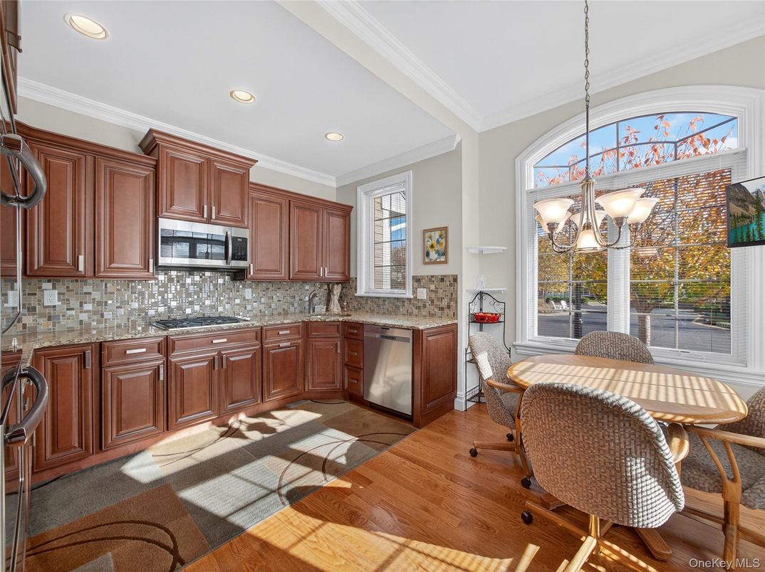 Chandelier, Dining room, Interior, Kitchen, Pendant Lights, Recessed Lighting, Stainless Steel Appliances, Wood Texture Flooring