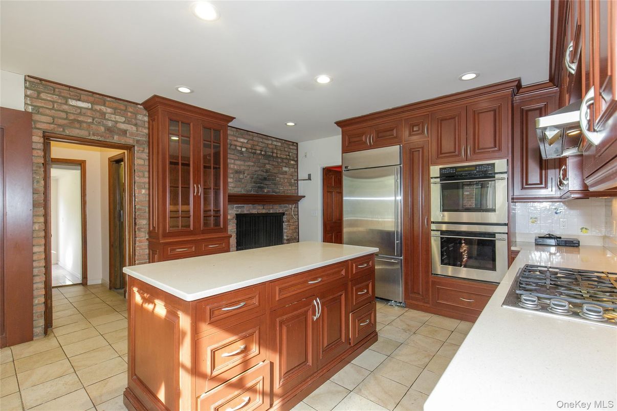 Fireplace, Interior, Kitchen, Recessed Lighting, Stainless Steel Appliances, Stone Walls