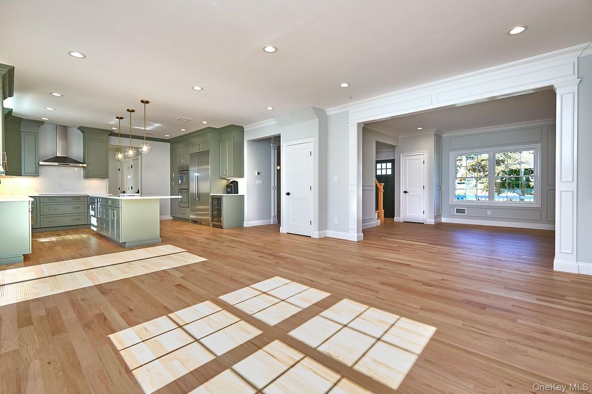 Empty room, Interior, Kitchen, Pendant Lights, Recessed Lighting, Stainless Steel Appliances, Wood Texture Flooring