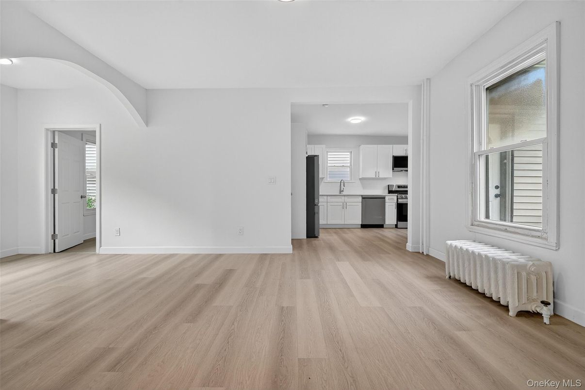 Empty room, Interior, Kitchen, Recessed Lighting, Stainless Steel Appliances, Wood Texture Flooring