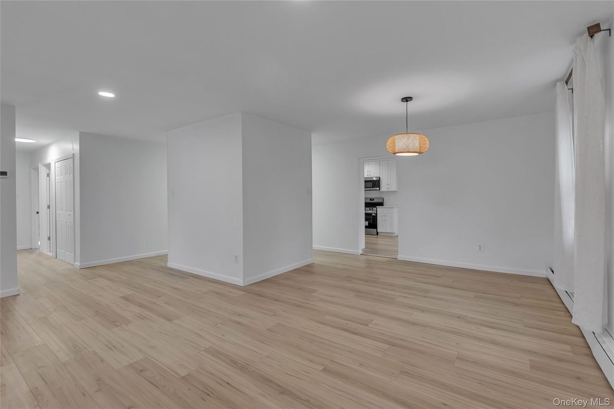 Empty room, Interior, Kitchen, Pendant Lights, Recessed Lighting, Stainless Steel Appliances, Wood Texture Flooring