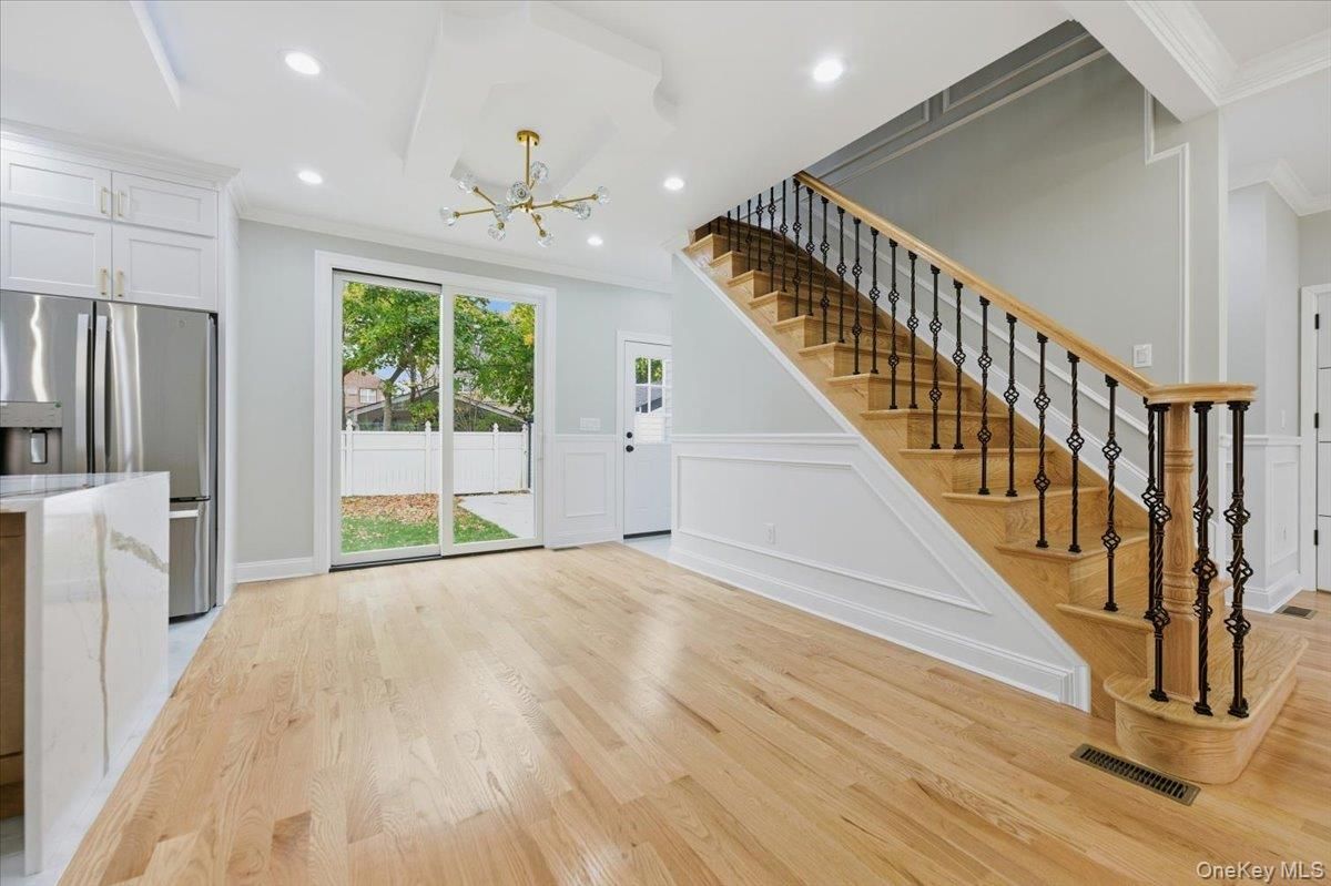 Empty room, Interior, Kitchen, Recessed Lighting, Stainless Steel Appliances, Wood Texture Flooring