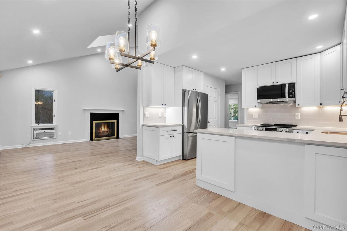 Fireplace, Interior, Kitchen, Pendant Lights, Recessed Lighting, Stainless Steel Appliances, Wood Texture Flooring