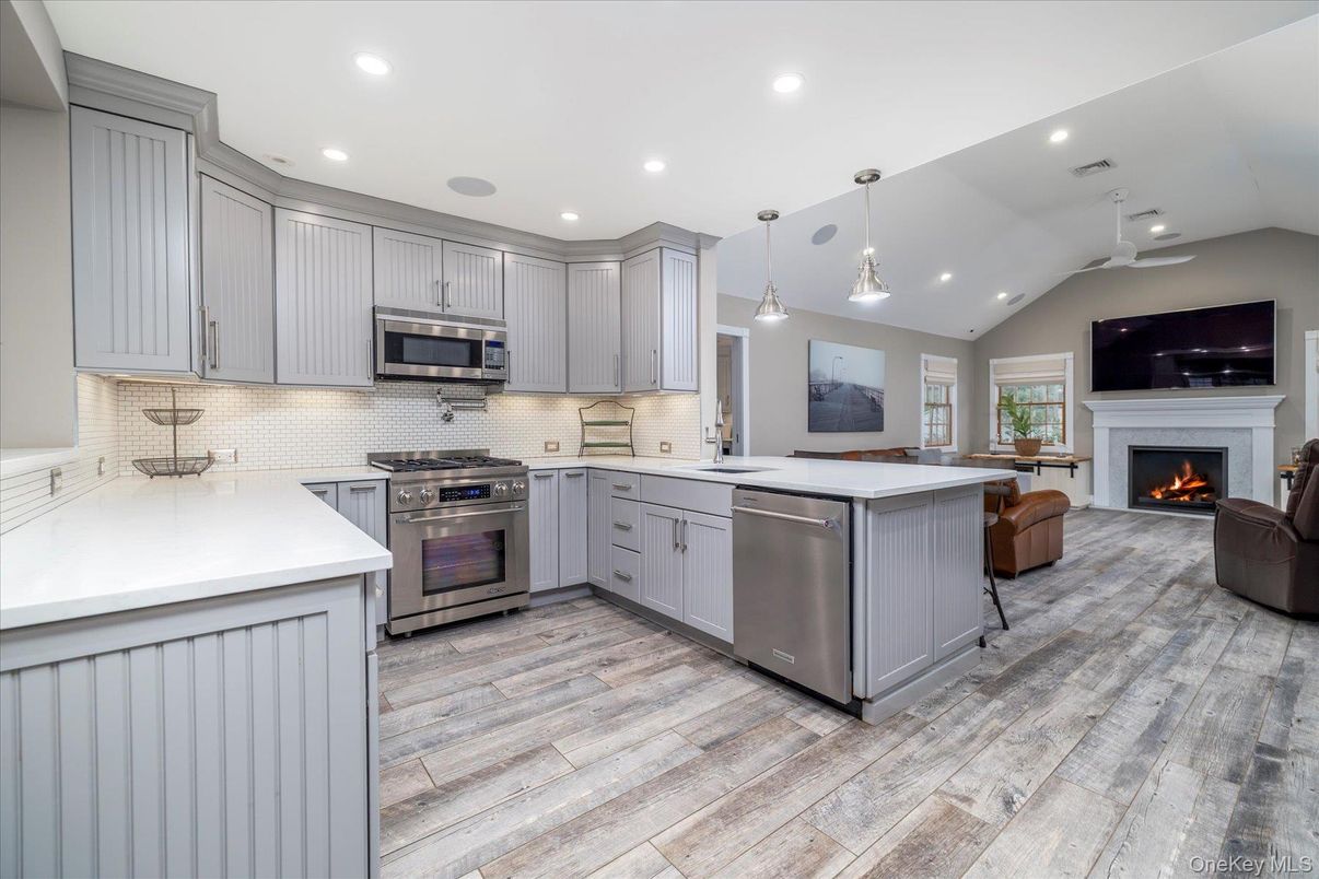 Fireplace, Interior, Kitchen, Living room, Pendant Lights, Recessed Lighting, Stainless Steel Appliances, Wood Texture Flooring