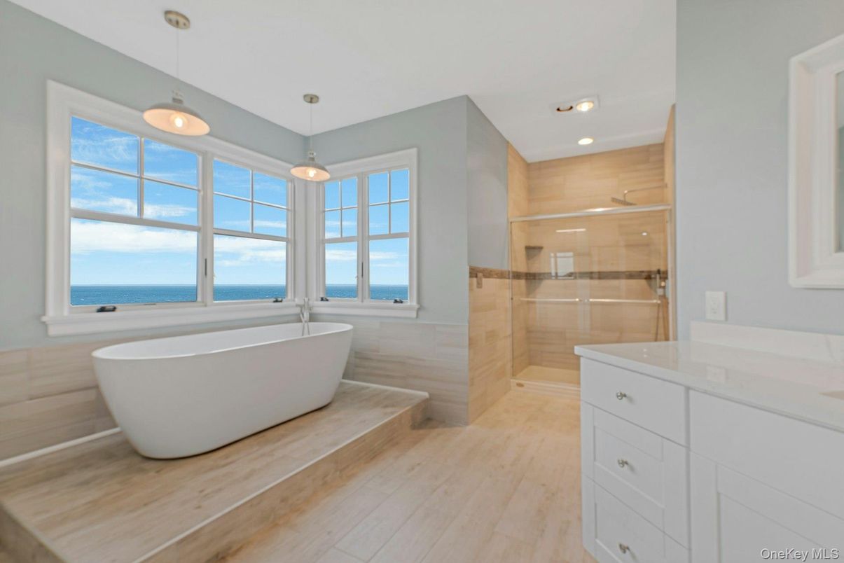 Bathroom, Free Standing Baths, Glass Shower, Interior, Pendant Lights, Recessed Lighting, Water, Wood Texture Flooring