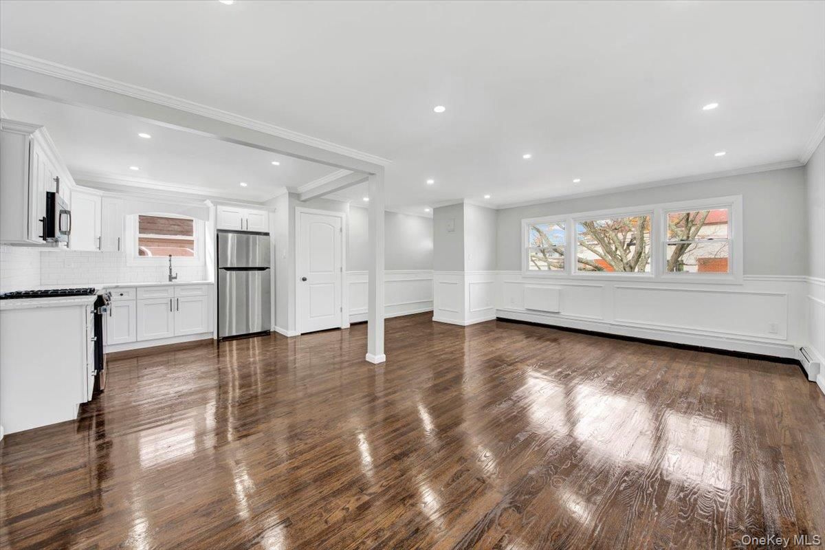 Empty room, Interior, Kitchen, Recessed Lighting, Stainless Steel Appliances, Wood Texture Flooring