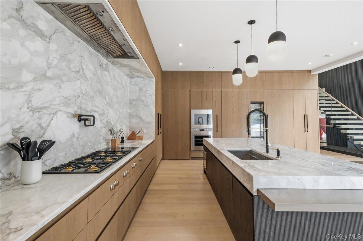 Interior, Kitchen, Marble Walls, Pendant Lights, Recessed Lighting, Stainless Steel Appliances, Wood Texture Flooring