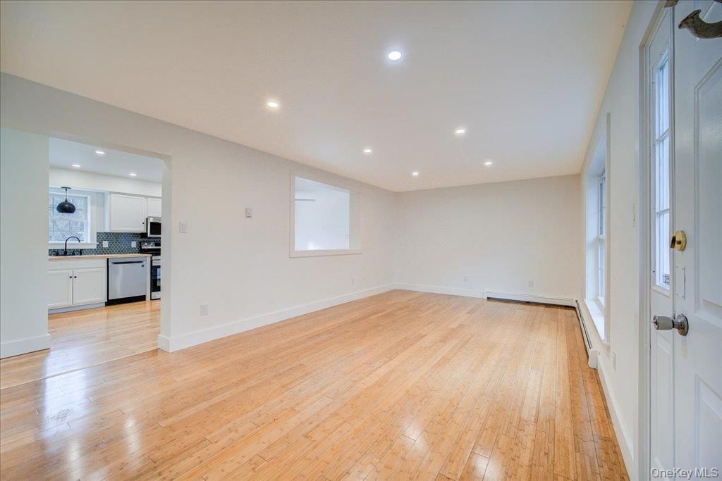 Empty room, Interior, Kitchen, Recessed Lighting, Stainless Steel Appliances, Wood Texture Flooring